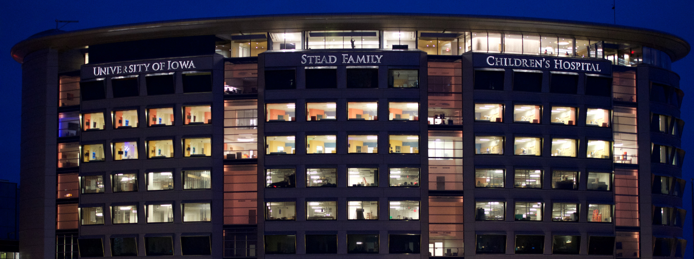 Exterior of UI Stead Family Children's Hospital lit up red at night