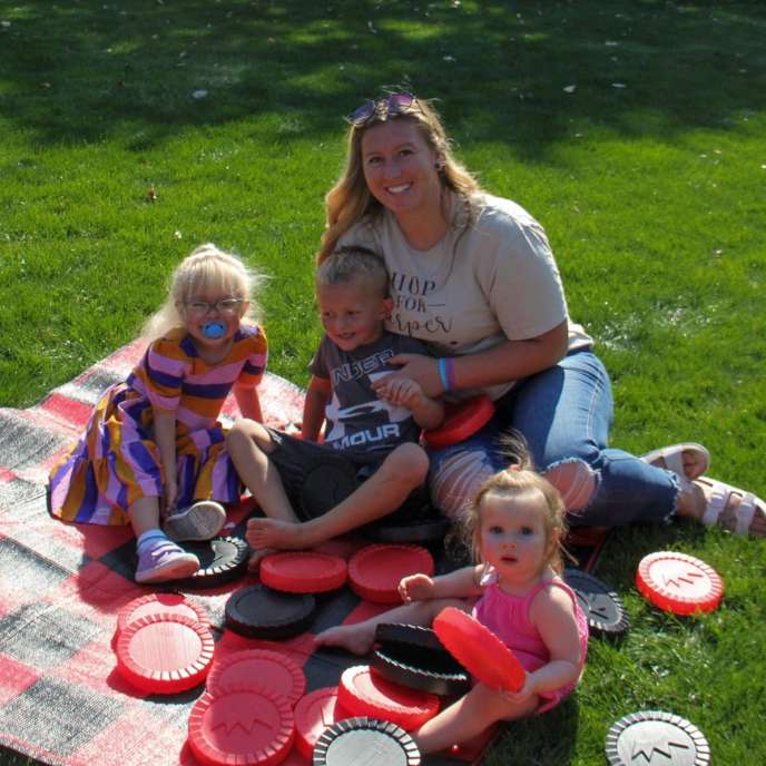 Family playing giant checkers at Stacks for Stead 2023